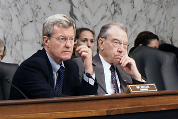 Sen. Max Baucus (D-MT) (left) sits next to Sen. Charles Grassley (R-IA).