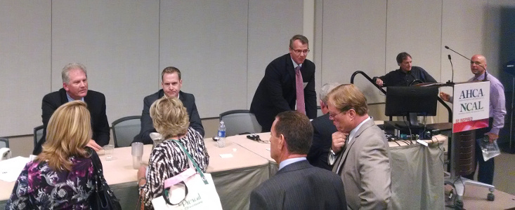 Hooper, Lundy and Bookman, PC's Mark Reagan, Mark Johnson, with AHCA's Mike Cheek, talk to attendees