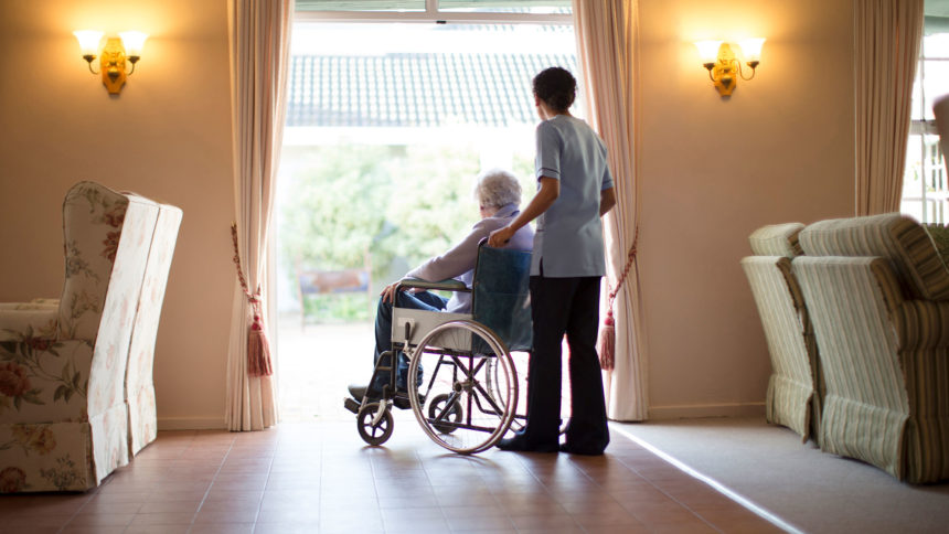 caregiver pushing senior in wheelchair