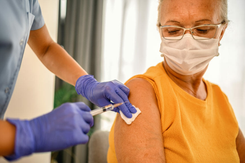 Closeup image of senior woman receiving a vaccination; Credit: Getty Images