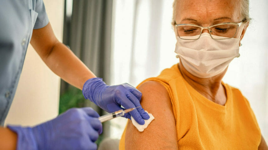 Closeup image of senior woman receiving a vaccination; Credit: Getty Images