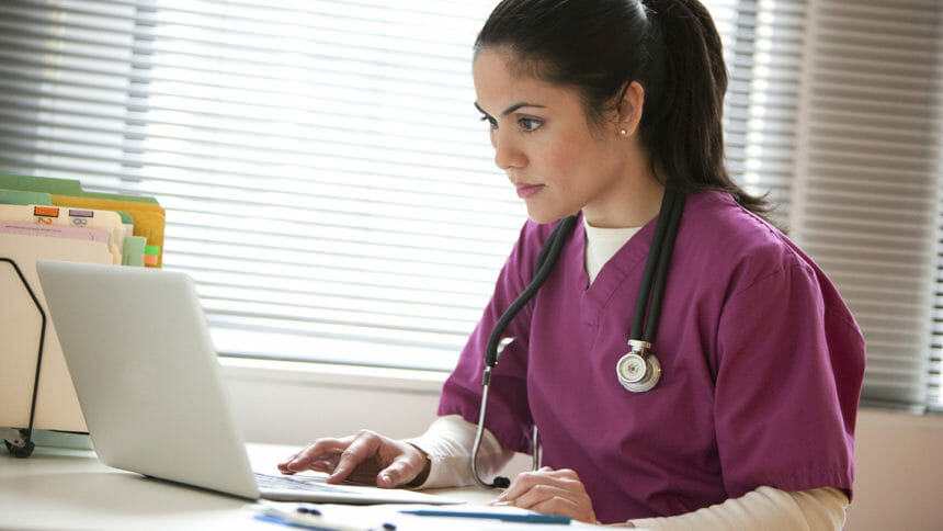 Image of nurse working at laptop
