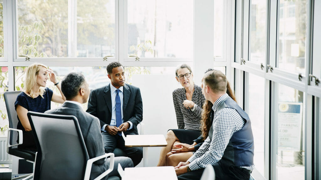 Mature businesswoman leading team meeting in conference room