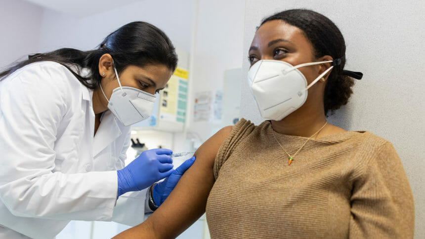 Woman receiving a vaccine shot against a virus
