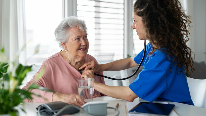 clinician, nurse checks seniors' heart with stethoscope