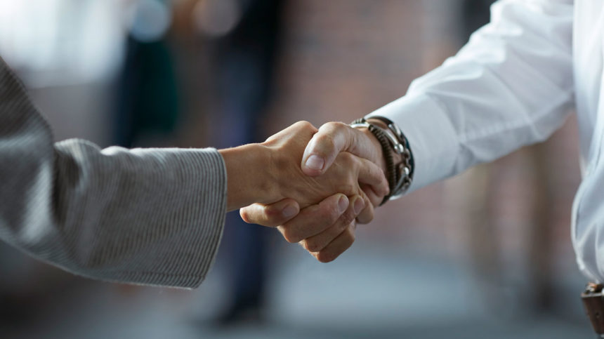 A handshake between a doctor and businessperson