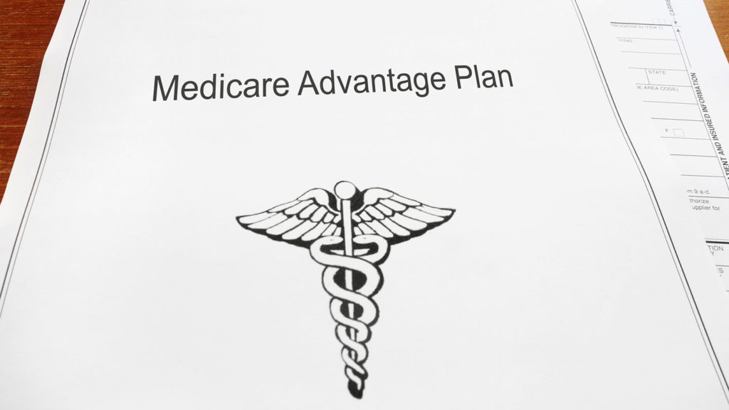 Medicare Advantage plan documents sitting on a table