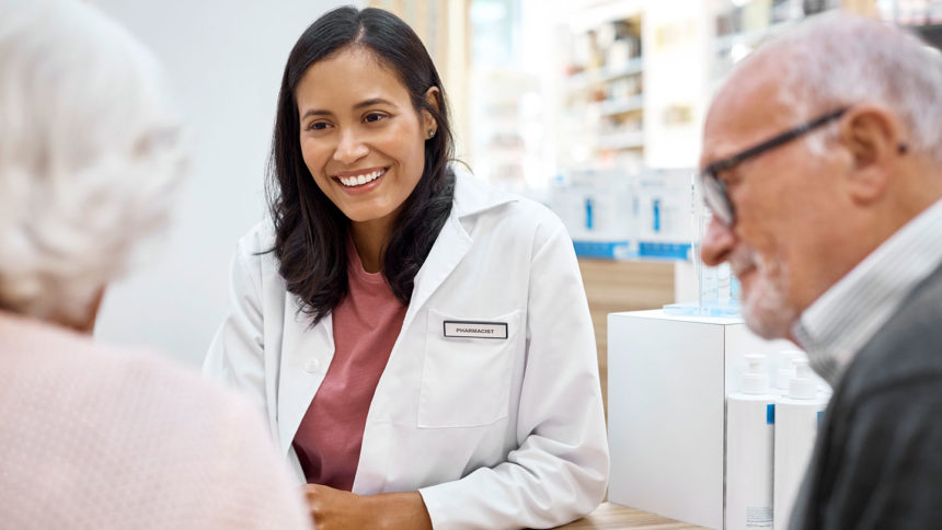 Image of pharmacist advising older adult patients; Credit: Getty Images