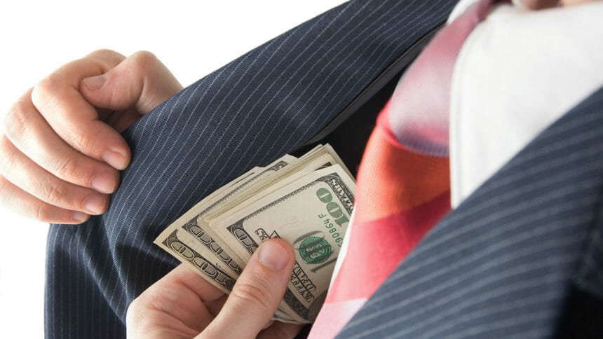 A greedy businessman hides money in his suit pocket