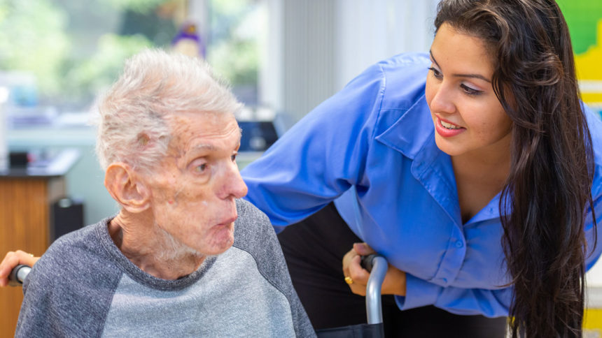 An immigrant nursing home worker helps a resident