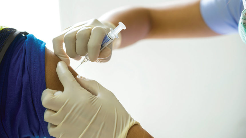 A healthcare worker receiving a vaccine shot