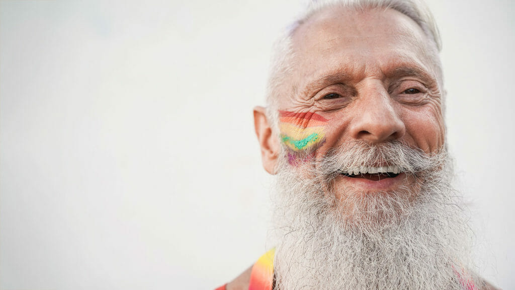 Senior gay man smiling during lgbt pride protest