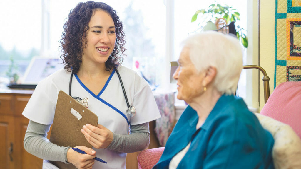 A Hawaiian nurse speaks with a nursing home resident