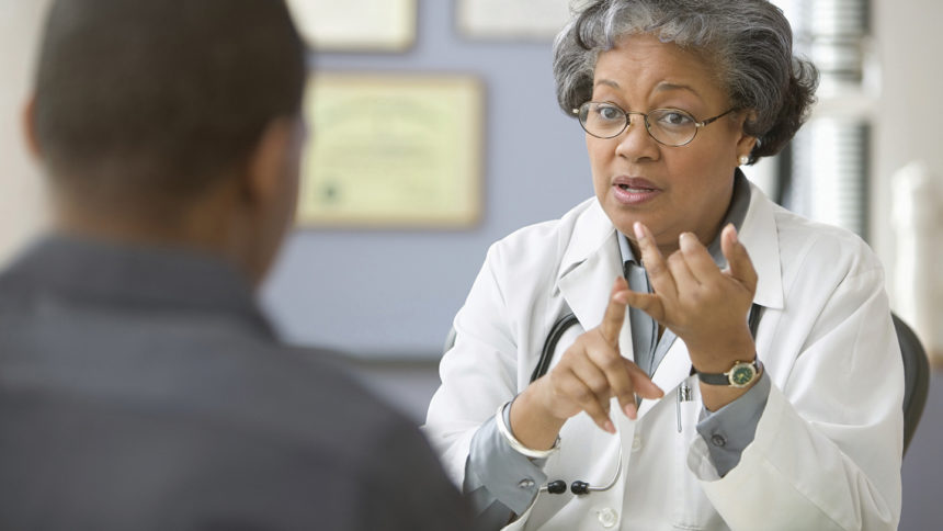 Image of female doctor talking with male patient