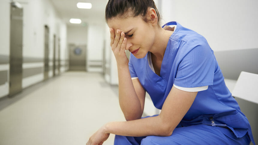 Female nurse suffering from headache