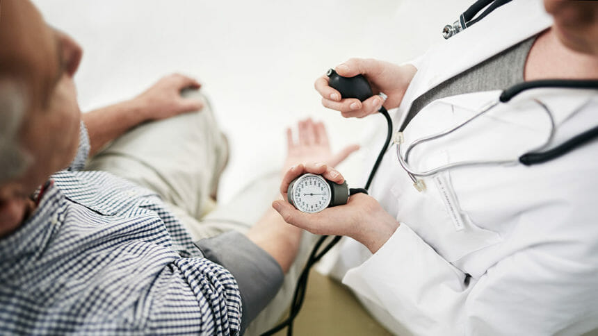 Shot of a doctor checking a senior patient's blood pressure in her office