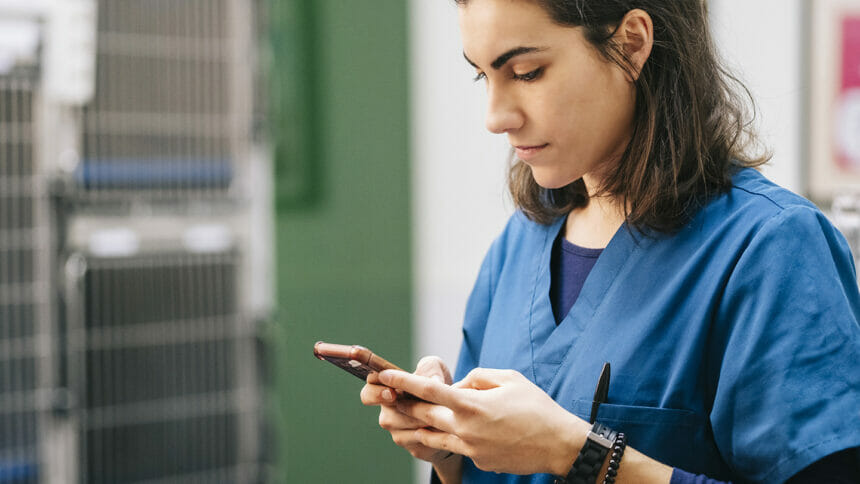 nurse using text messaging on her smart phone