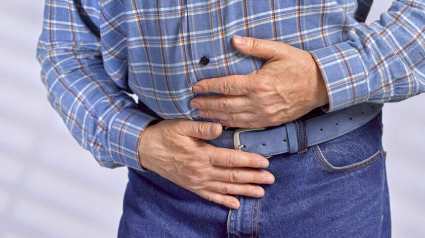 Closeup of man with stomach pain