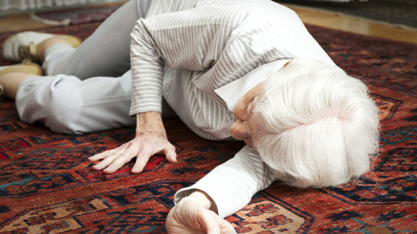 senior woman 90 years old lying on the floor after an accident