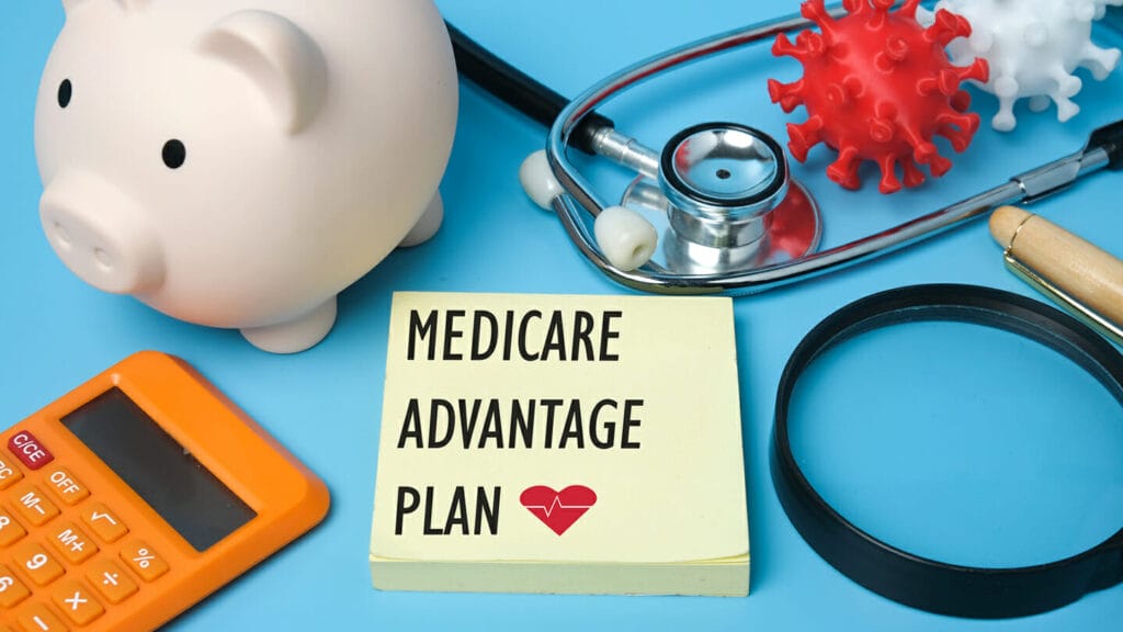 A picture of medicare advantage plan on notepad, stethoscope, coronavirus 3D printing, piggy bank and other prop insigh